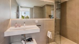 a bathroom with a sink and a shower at The Hype Beachhouse in Playa de Palma