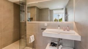 a bathroom with a sink and a shower at The Hype Beachhouse in Playa de Palma