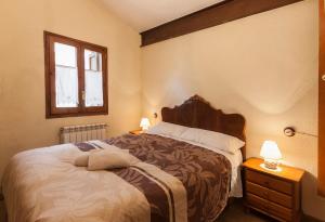 a bedroom with a large bed and a window at Cal Martí in Farena