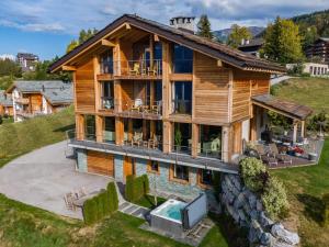 
a large house with a large window at Chalet Grand Loup in Nendaz
