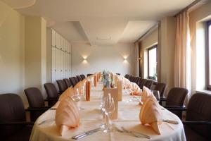 a long table in a room with chairs at Hotel Villa am Rhein in Andernach
