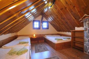 a room with two beds in a attic at Privat Beata in Hrabušice