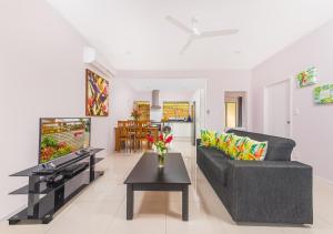 uma sala de estar com um sofá e uma mesa em Rarotonga GolfSeaView em Rarotonga