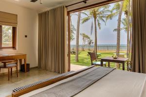 a bedroom with a bed and a view of the ocean at Jetwing Villa 700 in Bentota
