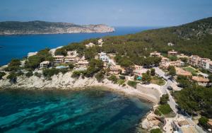 an aerial view of a village on a rocky island in the ocean at PuntBlanc Residences in Sant Elm