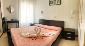 Postel nebo postele na pokoji v ubytování Hotel Graziana