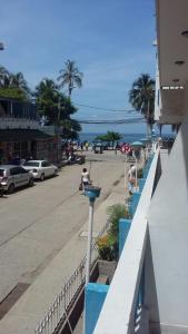 a view of a street with palm trees and a building at Karey 102 in Santa Marta