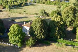 an aerial view of a house surrounded by trees at Domaine de Lalat - B&B with en-suite bathrooms all rooms with garden views in Montembœuf