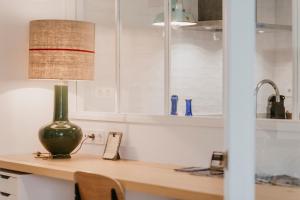 a lamp sitting on a counter in a kitchen at Apartamento Loiola in Azpeitia +37 photos