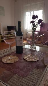 a bottle of wine and two glasses on a table at Sol y Luz in Isla del Moral