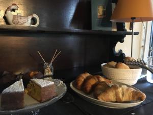 a table topped with a plate of bread and pastries at Locanda SottolaLuna in Viano