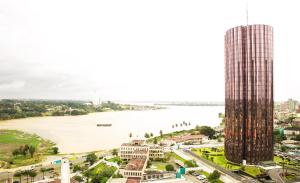 a view of the mekong river and a skyscraper at Résidence ATTA in Abidjan