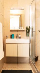 a bathroom with a sink and a mirror at Résidence ATTA in Abidjan