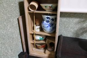 a wooden shelf with bowls and bowls on it at 2 floors japanese style, direct to KIX, 10mins train to Namba, 5mins walk to stn , 2-6ppl in Osaka