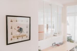 a framed picture on a wall in a room with windows at Apartamento Loiola in Azpeitia +38 photos