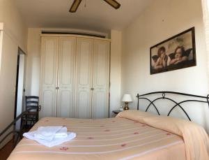 a bedroom with a bed and a large white cabinet at B&B La Finestra sui Trabocchi in San Vito Chietino