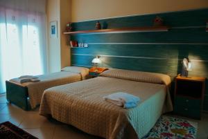 Ліжко або ліжка в номері La Villa Resort Pignola