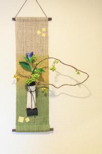 a hanging picture of a plant in a vase with butterflies at Higashiyama Chitaru in Kanazawa in Kanazawa