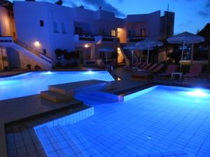 a large swimming pool with blue lighting in front of a building at Jechrina in Kato Daratso