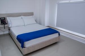 Una cama o camas en una habitación de Hotel Suite del Parque