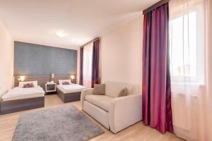 Posteľ alebo postele v izbe v ubytovaní Triple M Hotel