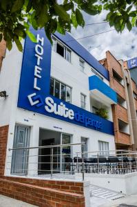 a building with a blue sign on it at Hotel Suite del Parque in Medellín