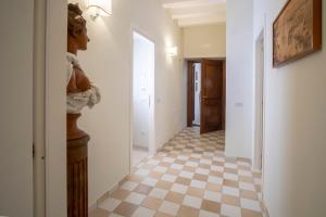 a hallway with a checkered floor in a house at Rosa Magra Guest House in Sorrento