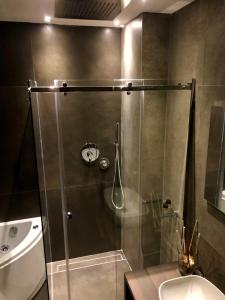 a shower with a glass door in a bathroom at Dimora Augusteo in Naples +27 photos