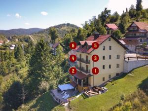 a house on a hill with red circles on it at Villa MOYA in Fužine