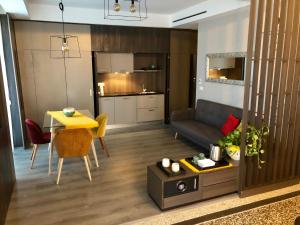 a living room with a table and a couch and a kitchen at Dimora Augusteo in Naples