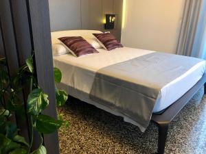 a bed with two pillows on it in a bedroom at Dimora Augusteo in Naples