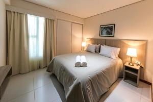 Rúm í herbergi á Asuncion Rent Suites Centro