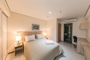 Rúm í herbergi á Asuncion Rent Suites Centro