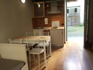 a kitchen with a table and chairs in a room at Bramantesco in Bergamo