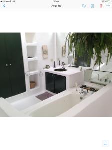 a bathroom with a bath tub and a sink at Patio I in La Asomada