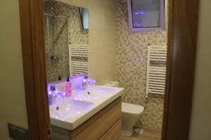 a bathroom with a sink with lights on it at Rosalía de Castro, 41 - Centro - VUT-CO-01904 in Santiago de Compostela +63 photos