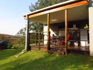 a house with a deck with a table at Eden Cottage in White River