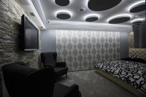 a bedroom with a bed and a flat screen tv at Wellness Apartmán Relax in Český Těšín