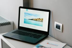 a laptop computer sitting on top of a desk at Bike&Boat Argentario Hotel in Porto Santo Stefano