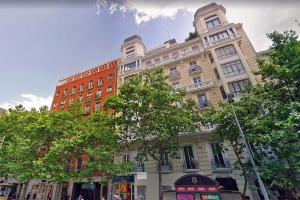 a large building on a city street with trees at Serrano Comfort, by Presidence Rentals in Madrid