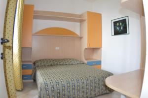 a small bedroom with a bed in a room at Residence Villa Miky in Albenga