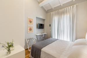 a bedroom with a bed and a television at Tenuta Petra Bianca in Palau