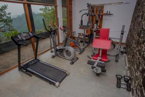 a gym with several exercise equipment in a room at Nalanda Residence in Diyatalawa