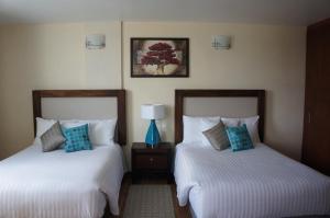 A bed or beds in a room at Hotel Mirante Tlaxcala