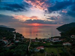 a view of a city and the ocean at sunset at Elisabeth Villas in Kerveli