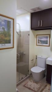 a bathroom with a shower and a toilet and a sink at Pico De Loro - Myna B Studio in Nasugbu