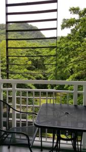a table and chairs on a balcony with a view at Pico De Loro - Myna B Studio in Nasugbu