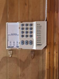 a remote control box hanging on a wooden wall at Cabañas Sra. Flor in Villarrica