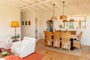 a dining room and living room with a table and chairs at Wood House in José Ignacio +22 photos