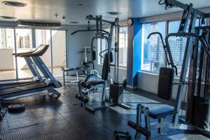 a gym with several treadmills and machines at Hotel Dan Inn São José dos Campos in São José dos Campos